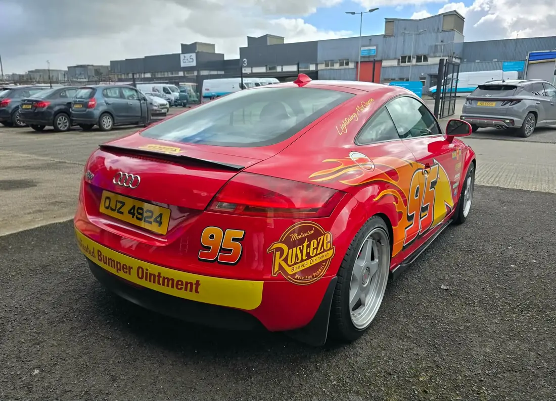 Rear view of the red race car in a car park